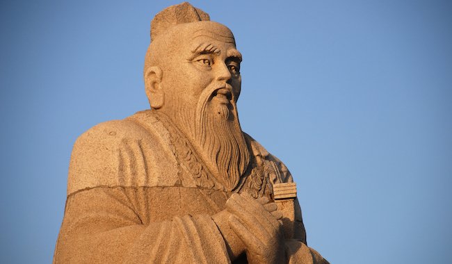 An old stone statue of Confucius