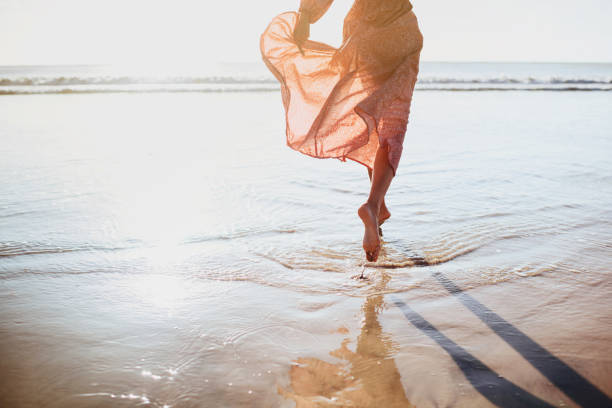 Young woman running on seaside path. summer time.